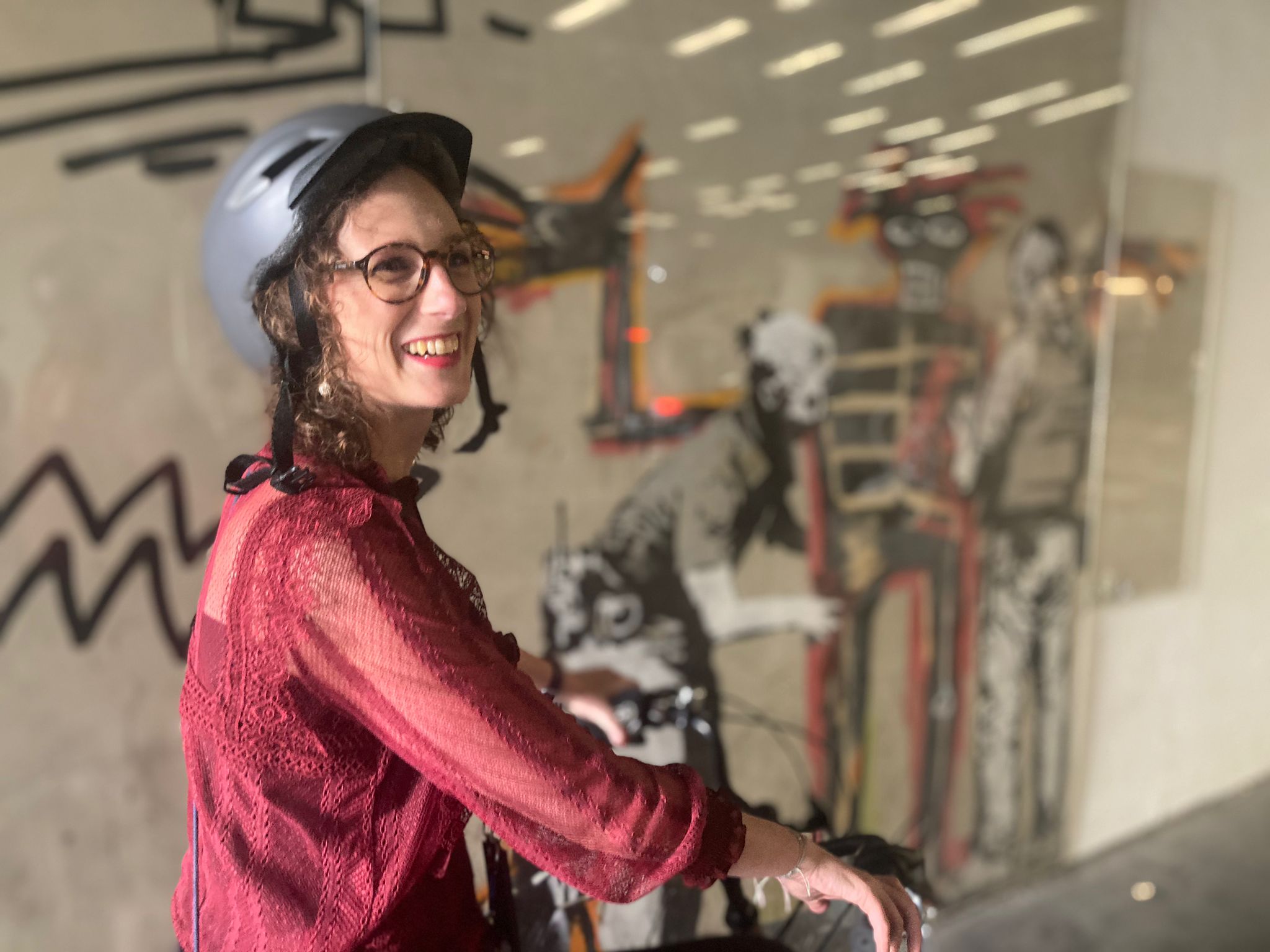 A half-length photo of Marika on your bike, wearing a helmet.